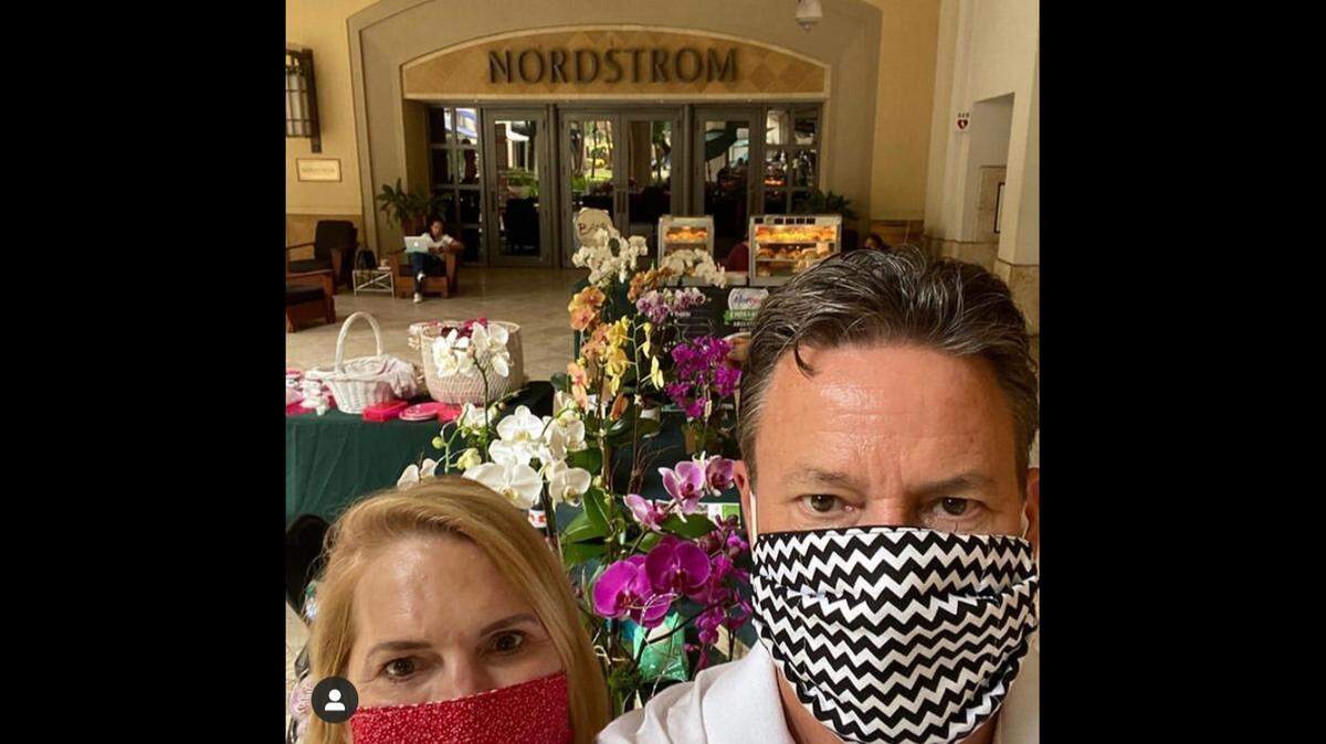 Ellen Graham and Brian Rivers of E&B Orchid Exchange are local vendors who set up again May 24 at the reopened Sunday Farmers Market at Shops of Merrick Park.