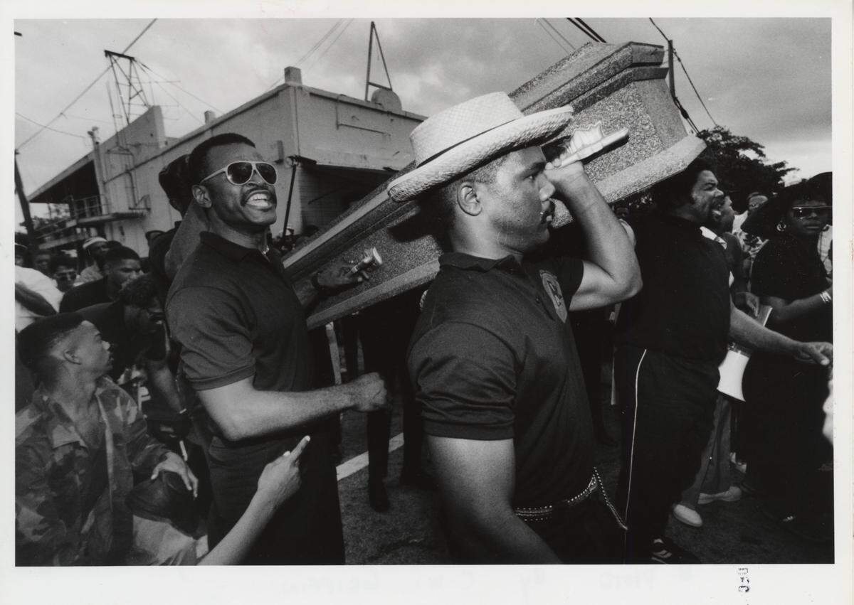 Asi Niamaya and James Mackey help carry a mock coffin through Overtown in 1989 during a demonstration over the killing of two Black motorcyclists by a Miami Police Officer.