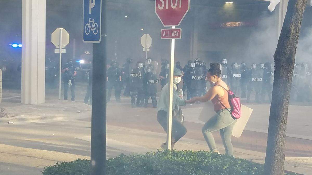 LaToya Ratlieff was being led away from tear gas by another marcher at an anti-police brutality protest in Fort Lauderdale May 31, 2021. Moments after this photo was taken a police officer shot her in the face with a foam rubber bullet, fracturing her right eye socket.