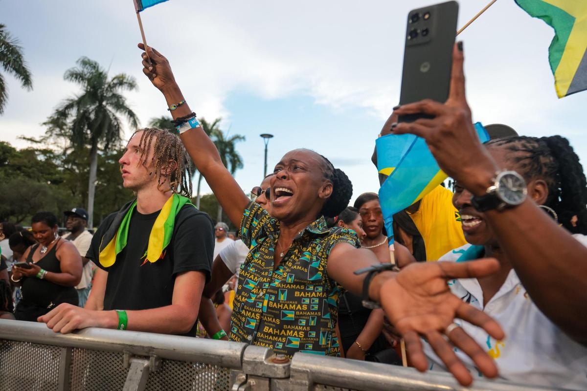 A woman wearing a shirt with Bahamian flags reacts to the sound of the music during the 19th annual Best of the Best International Music Festival at Bayfront Park in downtown Miami, Sunday, May 25, 2025.