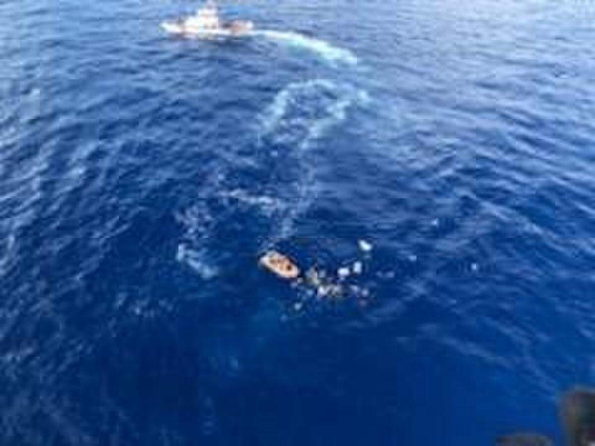 Six people are shown in the water after their boat began to sink 25 miles west of Sunny Isles Beach,, Florida., Saturday, April 6, 2019. The crew of the Coast Guard Cutter Cochito (WPB 87329), homeported in Miami, arrived on scene and rescued all six people from the water.
