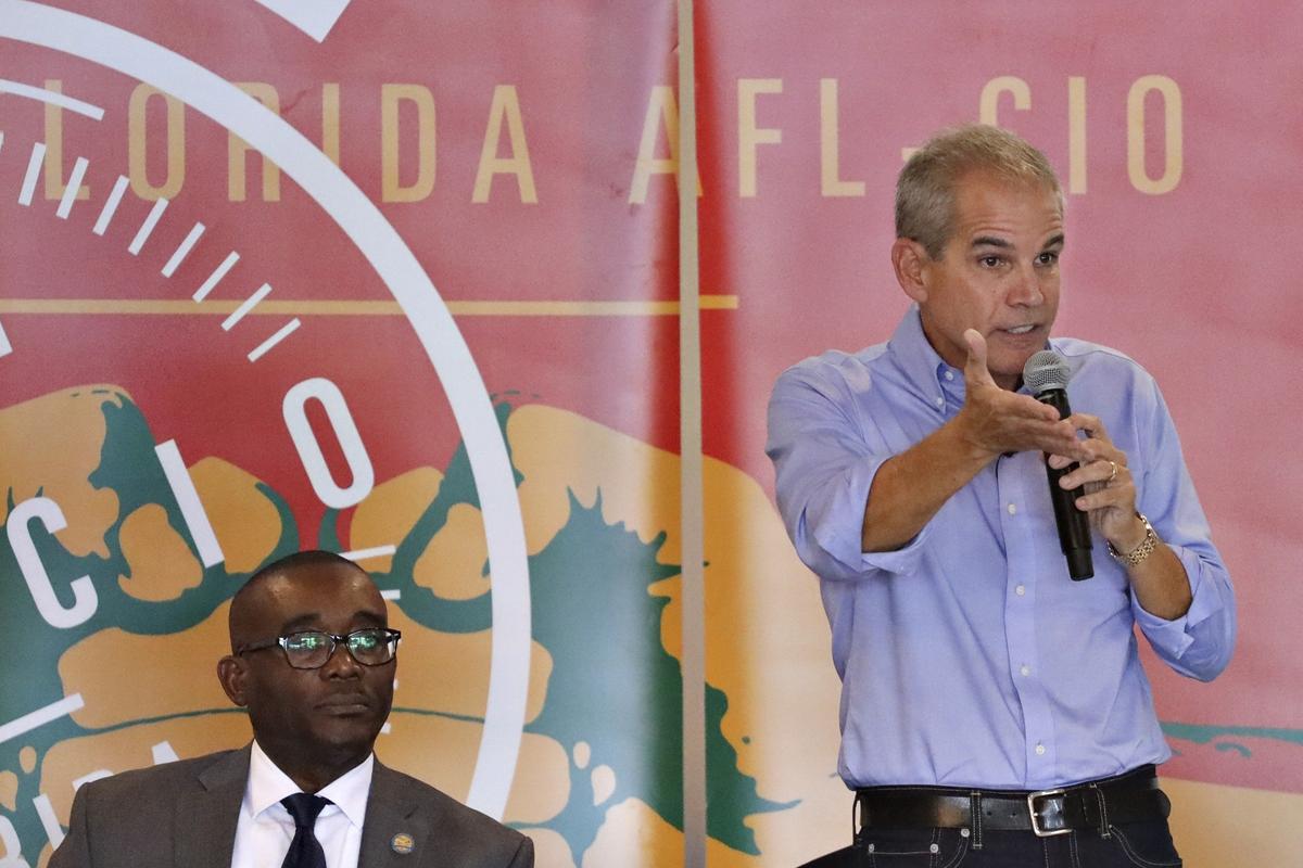 Mayoral candidate Alex Penelas, right, responds to a question as fellow candidate Jean Monestime listens during an October 2019 forum in a race where Penelas, a former two-term mayor, has raised the most money. He finished 2019 with about $2.8 million raised.