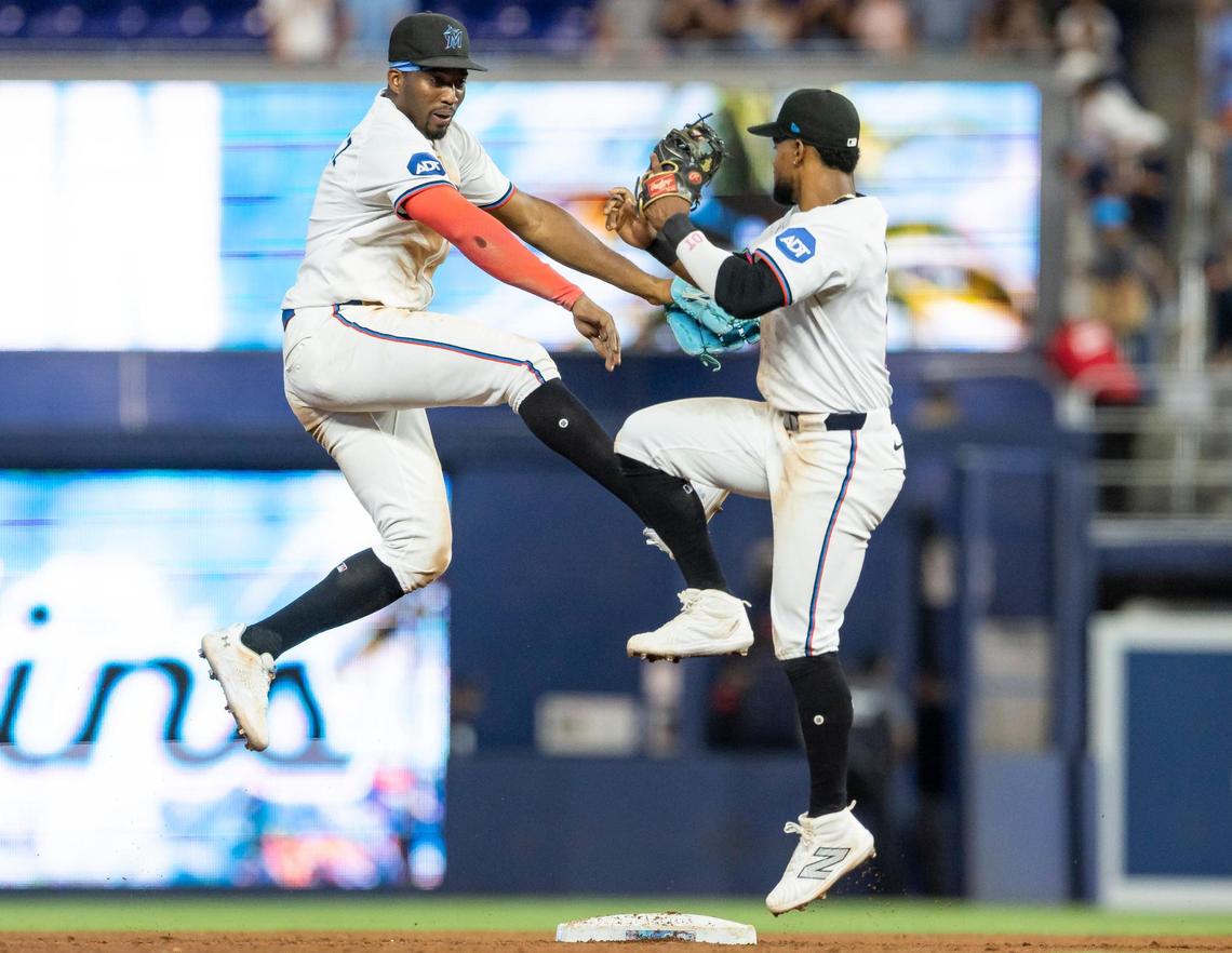 Miami Marlins right fielder Jesus Sanchez (7) and second baseman Otto Lopez (6) celebrate after they defeated the Minnesota Twins in their MLB game at loanDepot park on Thursday, July 3, 2025, in Miami, Fla.