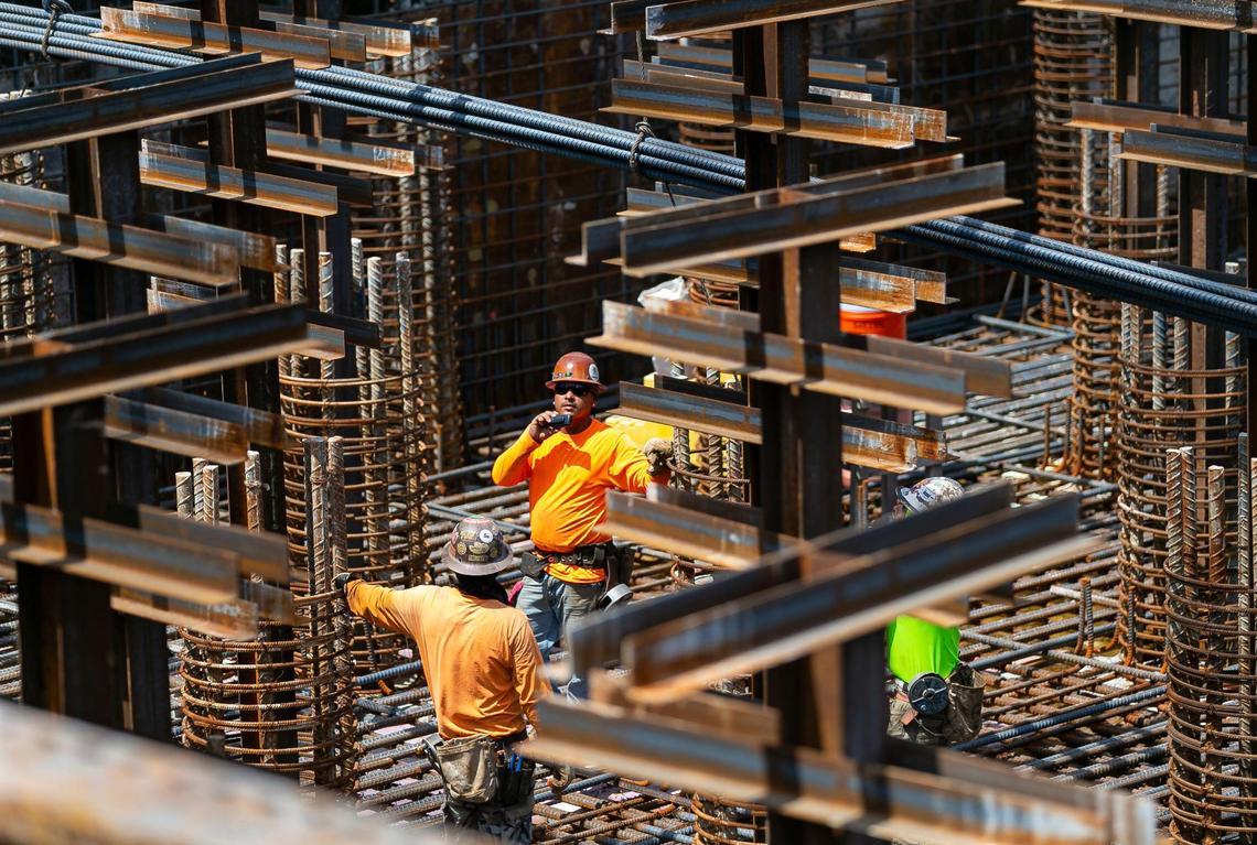 Employees work on the center pier foundation for the signature bridge being installed in downtown Miami on Tuesday, June 8, 2021.