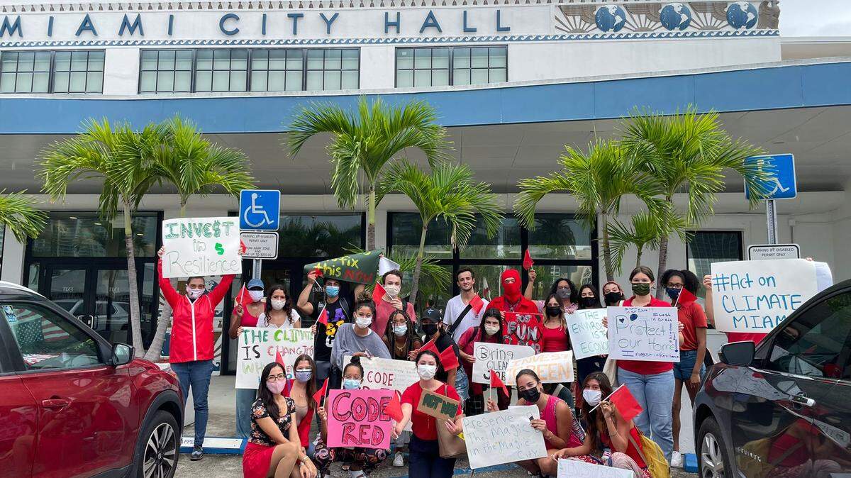 Activists with GenCLEO, a Miami-based climate advocacy group, rallied in front of Miami’s city hall to encourage commissioners to fund the city’s resilience department in the new budget.