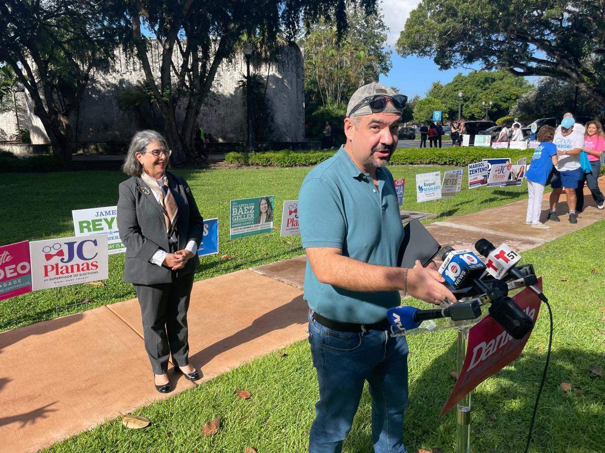 Christian Ulvert, owner of the Edge Communications political consulting firm, readies the lectern for a press conference by his top client, Miami-Dade Mayor Daniella Levine Cava, who is in the background. The event was at the Coral Gables Library early-voting site on Oct. 21, 2024, and Levine Cava was joined by multiple Ulvert clients seeking countywide office on Nov. 5.