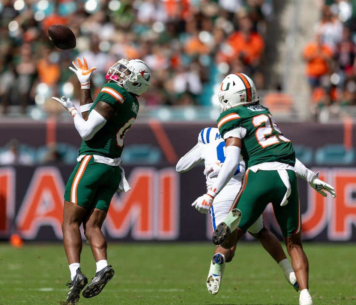 Miami Hurricanes defensive back Mishael Powell (0) intercepts a ball intended to Duke Blue Devils wide receiver Jordan Moore (8) during the first half of an ACC football game at Hard Rock Stadium on Saturday, Nov. 2, 2024, in Miami Gardens, Fla.