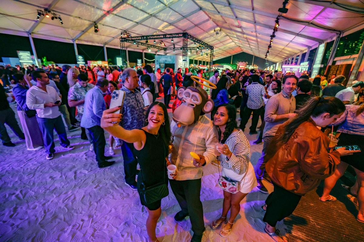 Manolo the Ape from The Bored Cuban restaurant in Miami poses for a selfie with guests at the 2025 Burger Bash 2025 in Miami Beach as part of the South Beach Wine & Food Festival.