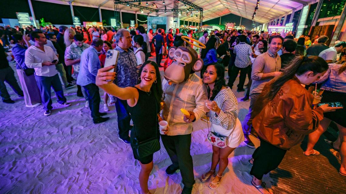 Guests take a selfie with Manolo the Ape, the mascot from The Bored Cuban restaurant in Miami, at the 2025 Burger Bash as part of the South Beach Wine & Food Festival. Burger Bash returns in 2026 on Feb. 19.