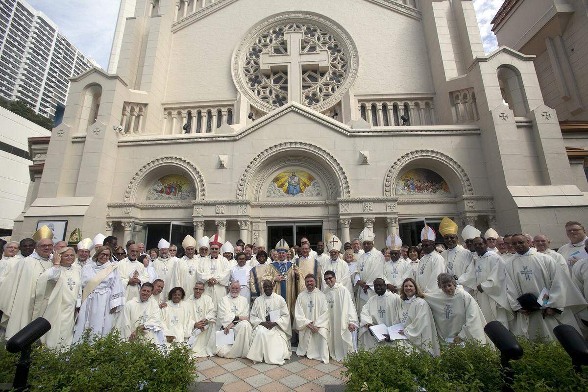 The Right Rev. Bishop Peter Eaton, center, is joined for a group portrait at Trinity Cathedral after his installation as head of the Episcopal Diocese of Southeast Florida. Sunday is Homecoming Sunday at Trinity.