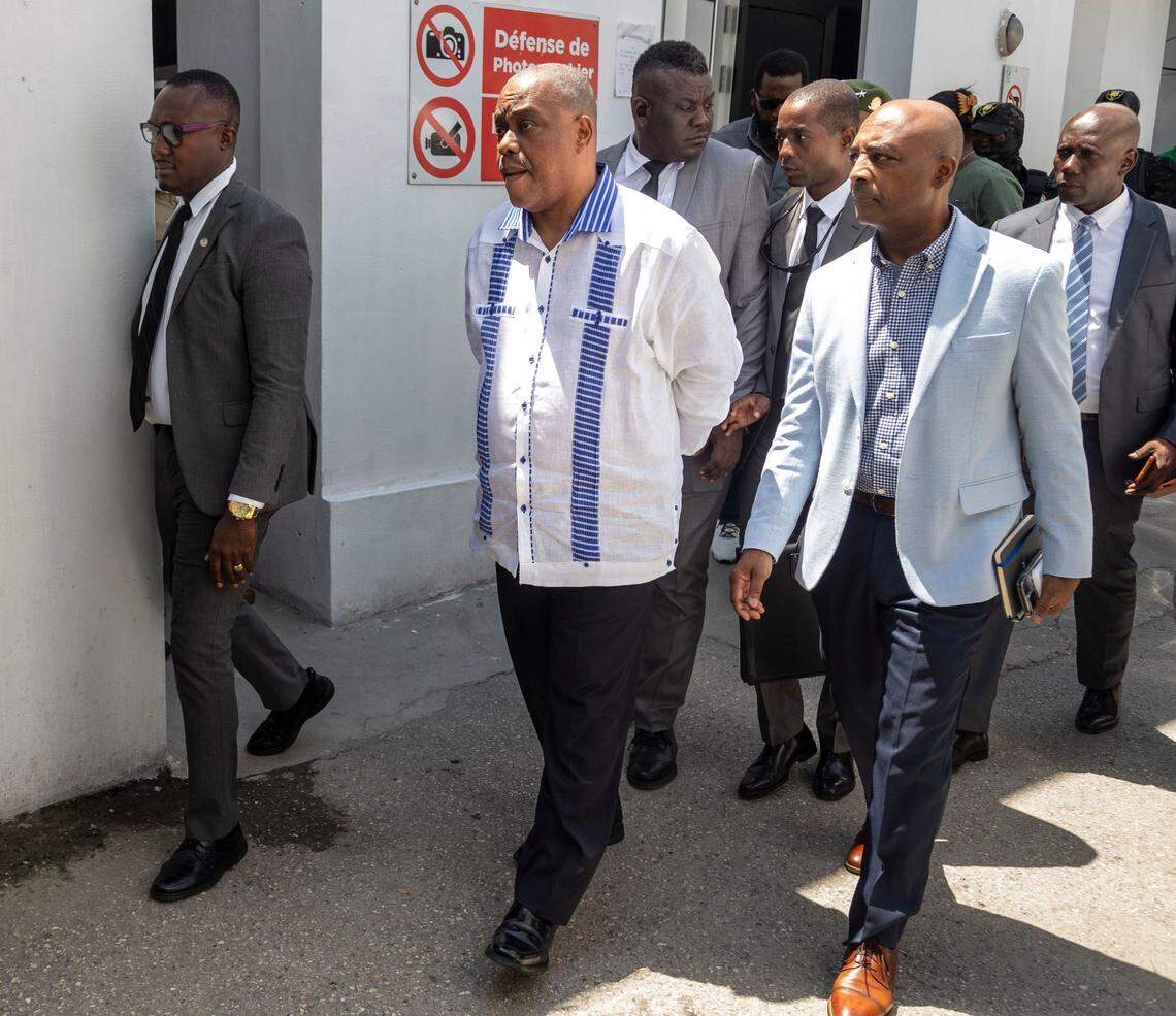 Haitian Prime Minister Gary Conille, center wearing white shirt, arrives at Hospital Bernard Mevs in late August to visit Haitian police officers who have been wounded while battling gangs in Port-au-Prince.