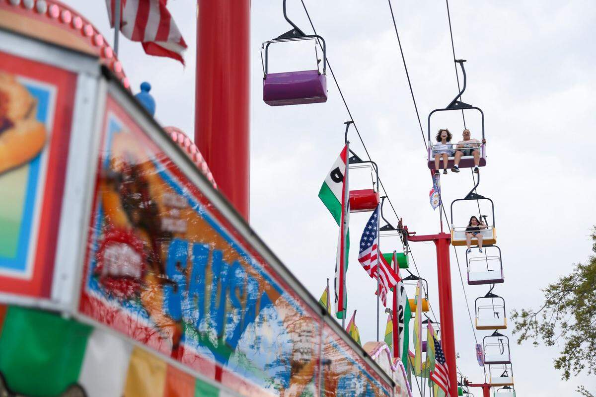 Fairgoers enjoy the view from the Sky Ride during the opening day of the Miami-Dade County Youth Fair at the Miami-Dade Fair & Expo Center in Miami, Florida, on Thursday, March 17, 2022.
