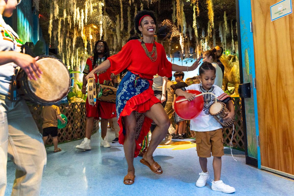 Maryann Artist Payne, center, dances with her son Shiloh Benjamin, 6, during a Juneteenth parade celebration at Miami Children’s Museum on Wednesday, June 19, 2024.