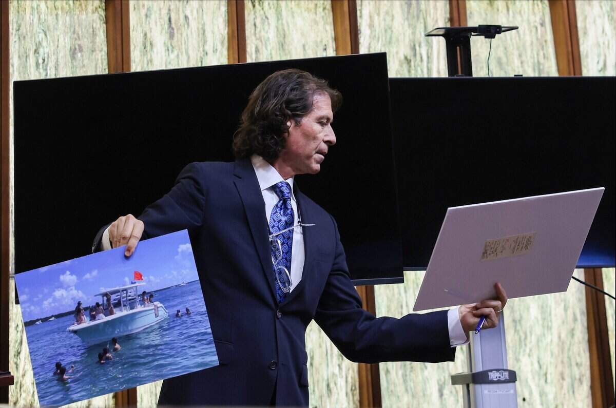 Defense attorney Howard Srebnick holds photos as he asks questions to Lt. Paul Alber, an expert in boating incidents, during the Pino trial on Monday, June 15, 2026, in Miami, Florida.  Pino is charged in connection to the crash that killed 17-year-old Lucy Fernandez.