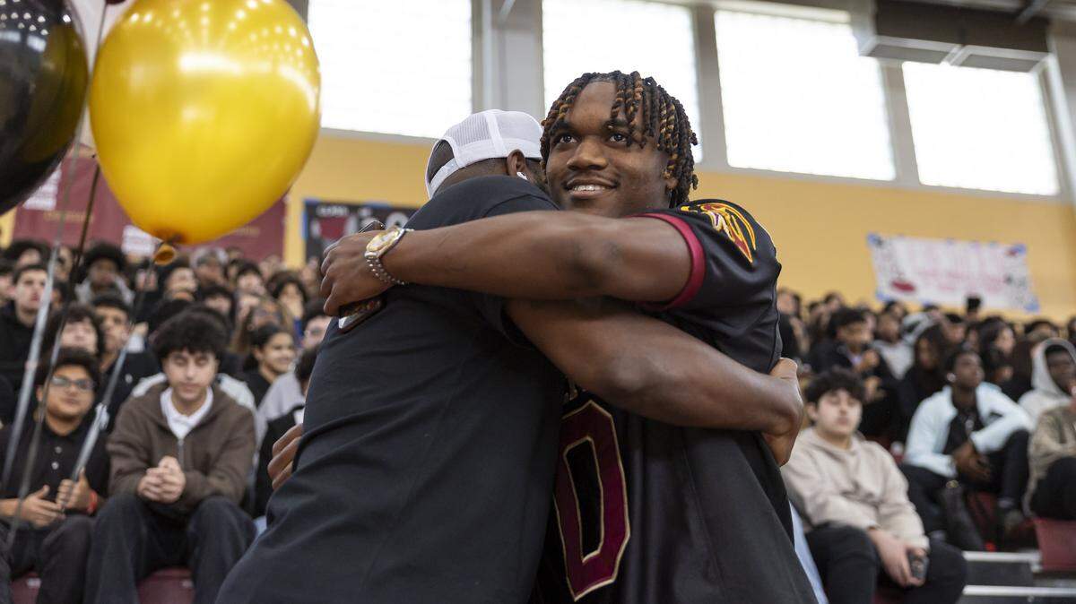 Darryl ‘Tre’ Bell III, center, a two-way football athlete, is congratulated during his college signing day ceremony inside of the gymnasium at Barbara Goleman Senior High School on Wednesday, Dec. 3, 2025, in Miami Lakes, Fla. Bell announced his commitment to play football for Florida State University during the event.
