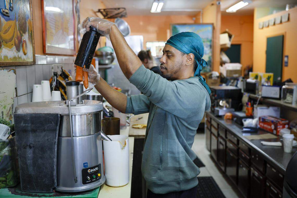 Employee Carlos Austin-Adamst prepares a juice drink at The Last Carrot.
