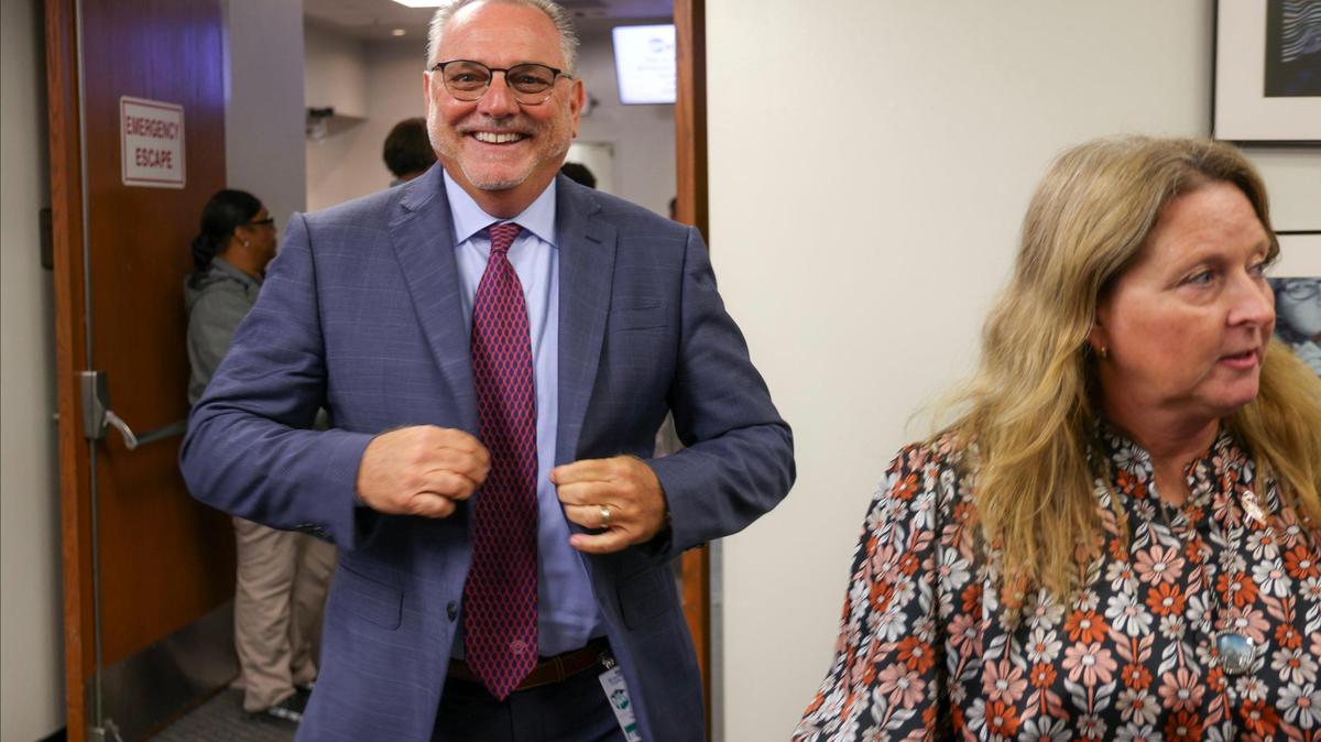 The new Broward County Public Schools Superintendent Peter Licata, left, buttons his jacket with a smile while exiting the the board room of the Broward School Board, Tuesday, July 11, 2023. The board unanimously approved a three-year contract for Licata Tuesday, agreeing to pay him an annual salary of $350,000.