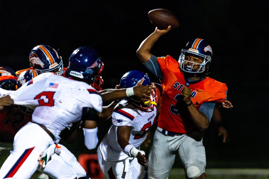 Homestead quarterback Joshua Townsend (3) passes the ball before being sacked by a Miramar defender during the first half of a high school football game at Harris Field Park in Homestead, Florida, on Friday, November 25, 2022.