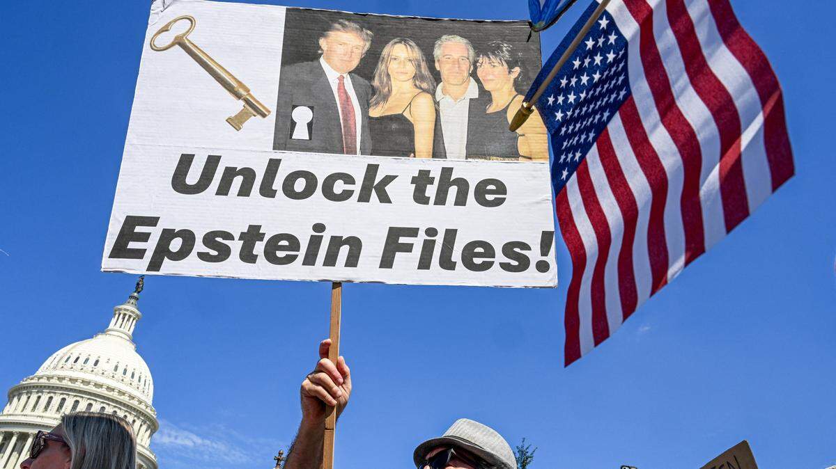 Demonstrators carry signs in support of the victims of sex offender Jeffrey Epstein and his accomplice Ghislaine Maxwell near a press conference held by US representatives outside the U.S. Capitol in Washington, DC on September 3, 2025.  