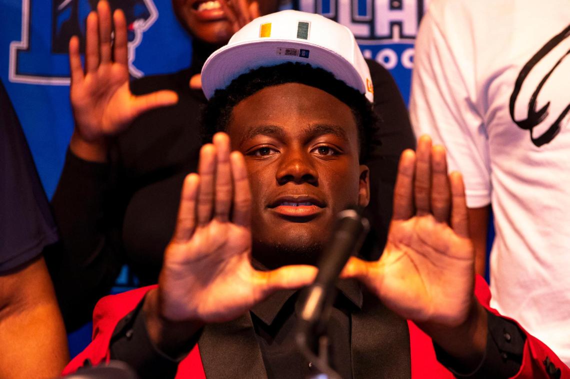 Four-star defensive lineman Nyjalik Kelly reacts by throwing up the ‘U’ after choosing to sign with University of Miami football during National Signing Day at Dillard High School in Fort Lauderdale, Florida, on Wednesday, December 15, 2021. Kelly made a recent decision to switch his school of choice from Oregon to Miami after the Hurricanes brought on Mario Cristobal as head coach.