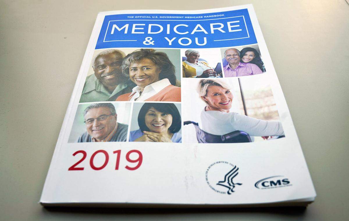 FILE - In this Nov. 8, 2018, file photo, the U.S. Medicare Handbook is photographed, in Washington. A new study finds that more than half of seriously ill Medicare enrollees, 53 percent, struggle to pay their medical bills. Prescription drugs are the leading problem. (AP Photo/Pablo Martinez Monsivais, File)