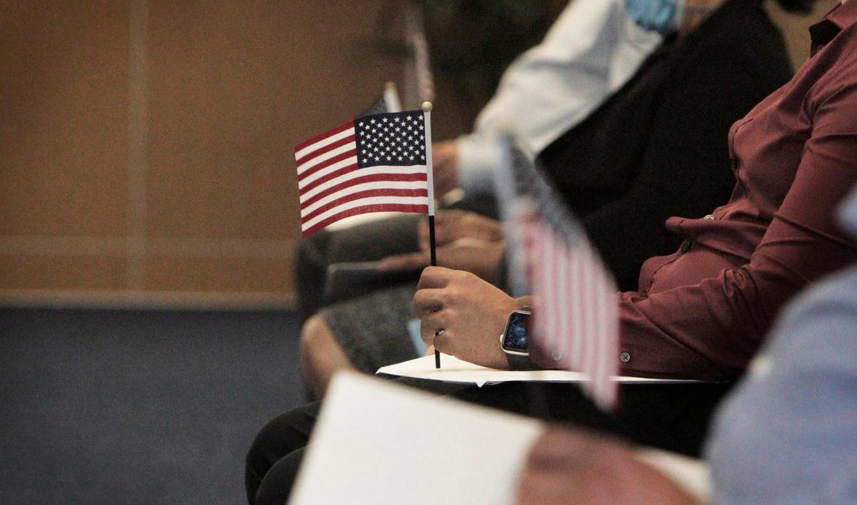 New American citizens wait to be called to get their certificate at a USCIS facility in West Kendall on June 4, 2020. The new ceremonies are shorter to limit exposure to those in attendance, and only 10 people at a time are sworn in. Under the shortened format, all legally required portions of the ceremony take place. Attendance is limited to the candidates who are scheduled to be naturalized, a parent or trusted adult if the candidate is a minor, and individuals providing disability assistance to a candidate.