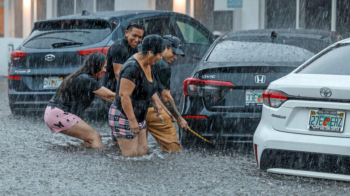 Christian B. and his two friends Claudia and Barbara tried to pull his car with a rope to keep it from crashing in the neighboring car to no avail in Miami Beach, Florida on Wednesday, June 12, 2024.