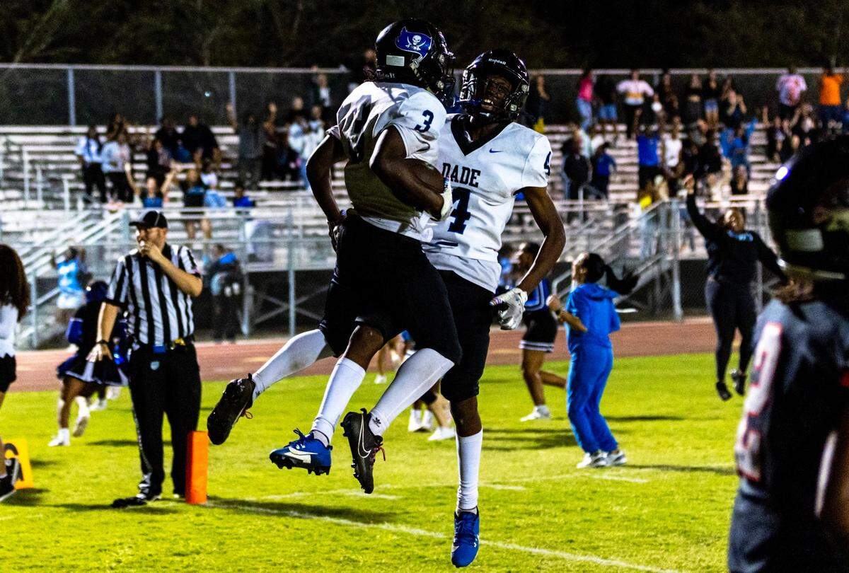 South Dade teammates Sedric Melvin and Edward Farley-Kendrick react to defeating South Ridge 33-30 after four quarters of a high school football game at South Ridge Stadium in Miami, Florida, on Friday, November 3, 2023.