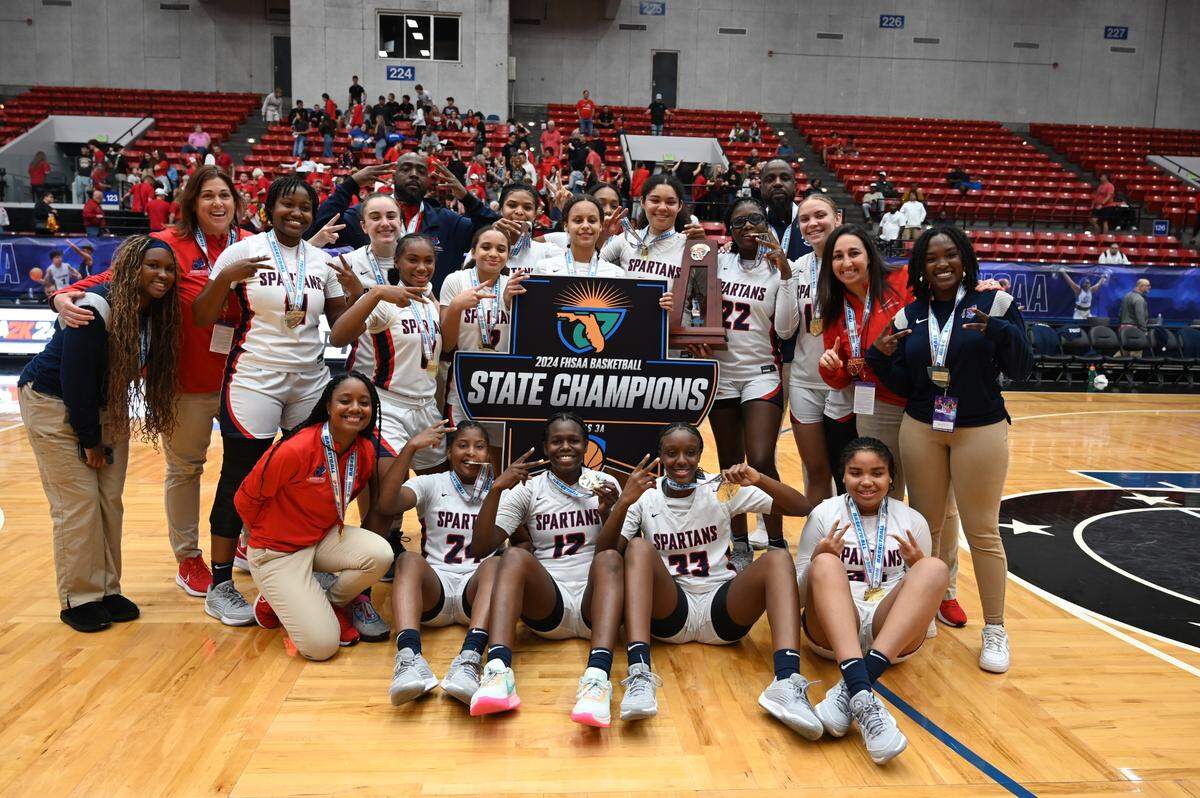Miami Country Day players celebrate the team’s Class 3A state championship at the RP Funding Center in Lakeland on Friday.