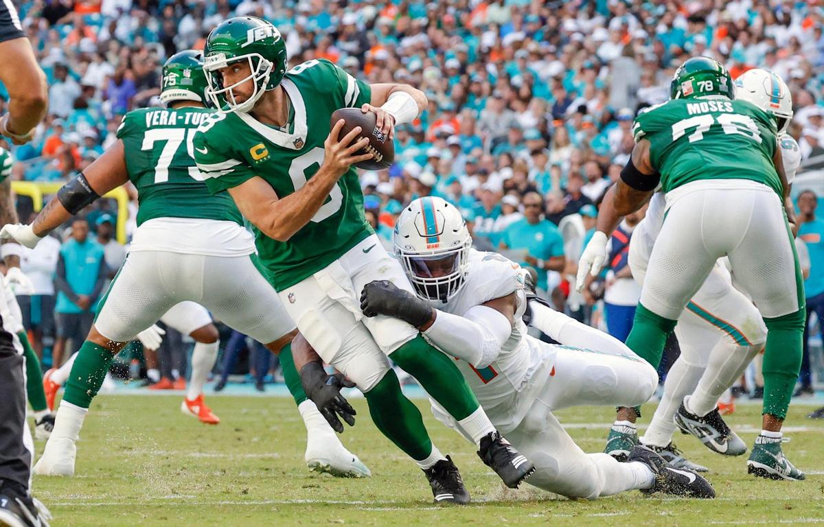 Miami Dolphins linebacker Emmanuel Ogbah (91) sacks New York Jets quarterback Aaron Rodgers (8) in the first half of their NFL football game at the Hard Rock Stadium in Miami Gardens, Florida on Sunday, December 8, 2024.