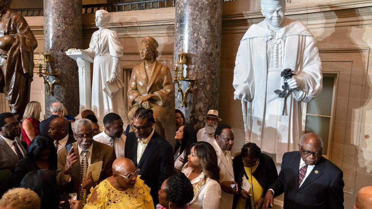 Evelyn Bethune, front left in yellow, a granddaughter of Mary McLeod Bethune, speaks with Rep. Sheila Jackson Lee, D-Texas, as members of the Congressional Black Caucus gather around an unveiled statue of Mary McLeod Bethune, at a ceremony for the statue, which is the first state statue of a Black woman in Statuary Hall, Wednesday, July 13, 2022, at the U.S. Capitol in Washington. Rep. James Clyburn, D-S.C., is at front right.