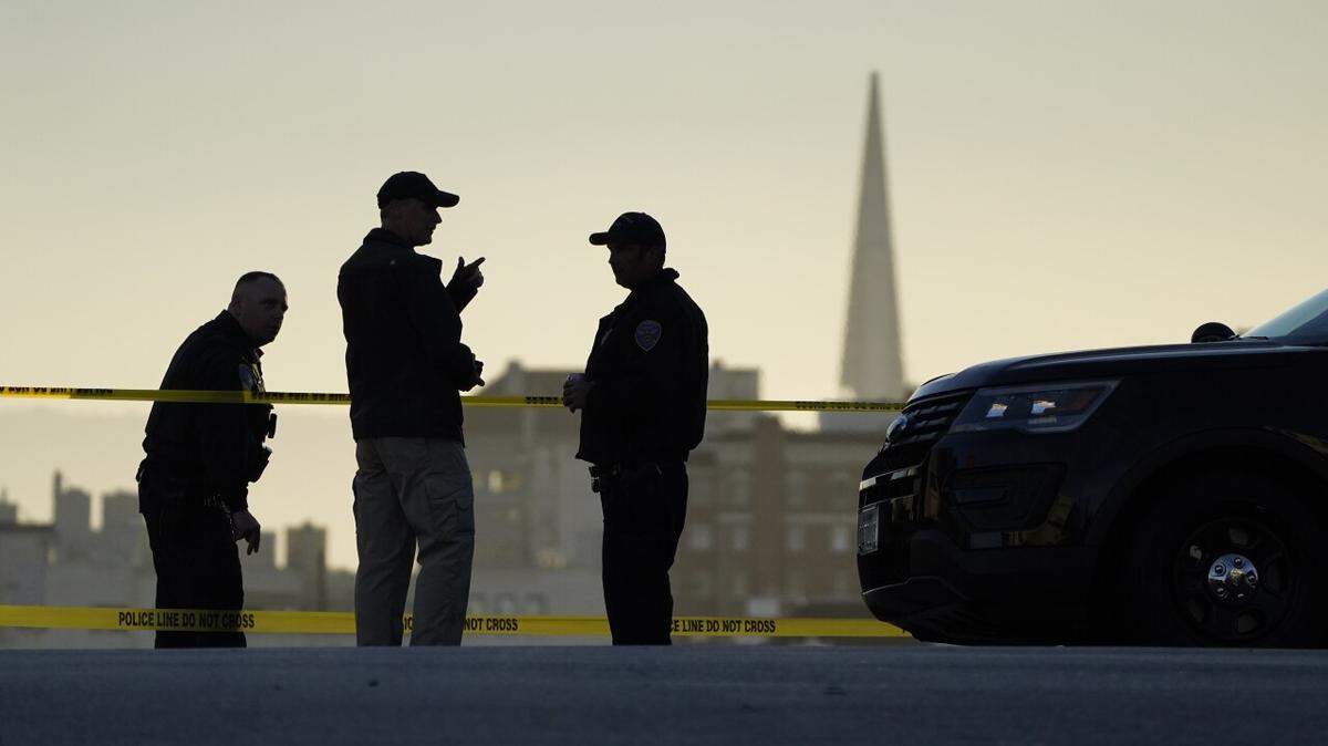 Police stand at the top of the closed street outside the home of Paul Pelosi, the husband of House Speaker Nancy Pelosi, in San Francisco.