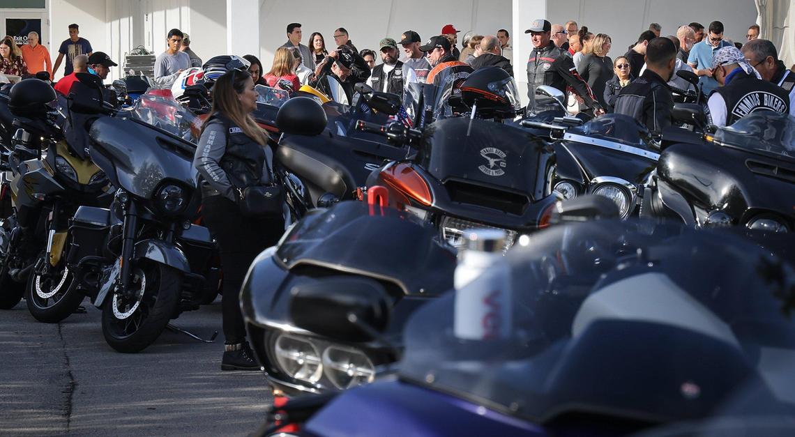 Riders exit Our Lady of Guadalupe Church and head to their motorcycles as approximately 350 riders prepare to take part in the 13th Annual Archbishop Motorcycle Ride.