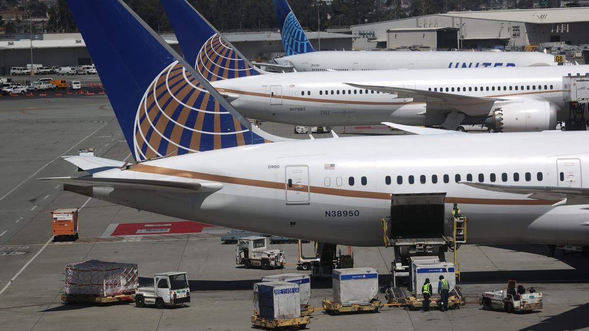 SAN FRANCISCO, CALIFORNIA - JULY 08: United Airlines workers load cargo onto a plane at San Francisco International Airport on July 08, 2020 in San Francisco, California. As the coronavirus COVID-19 pandemic continues, United Airlines has sent layoff warnings to 36,000 of its front line employees to give them a 60 day notice that furloughs or pay cuts could occur after October 1. (Photo by Justin Sullivan/Getty Images)