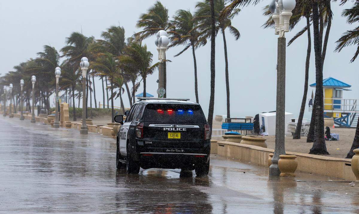 A City of Hollywood police patrol drives through a rain-soaked and empty Hollywood Beach Broadwalk on Monday, May 12, 2025. The National Weather Service in Miami forecasts widespread showers and thunderstorms, with a 90% chance of rain and 1 to 3 inches expected by Tuesday morning.