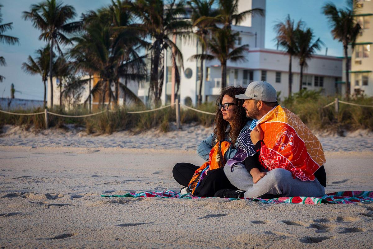 Carlos and Caridad Fernandez enjoy the sunrise and the cool temperature at the beach in Miami Beach on Friday, Jan. 3, 2025. Colder temperatures that may dip to the upper 40s could arrive on Tuesday, Jan. 8.