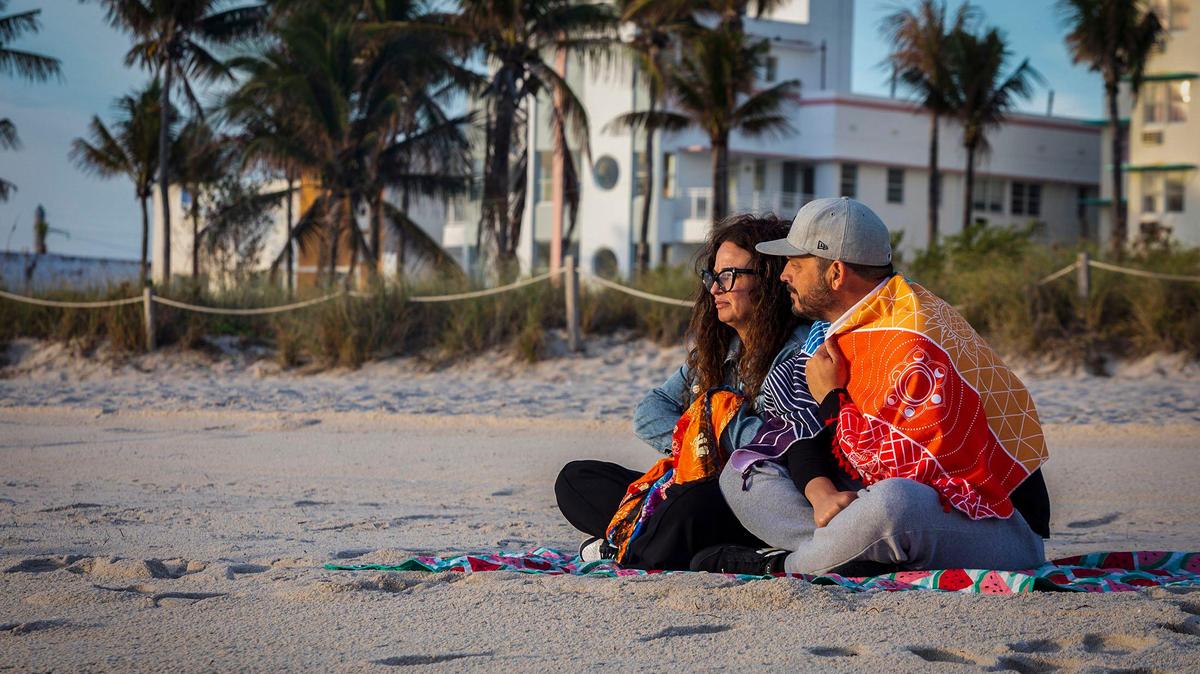 Carlos and Caridad Fernandez enjoy the sunrise and the cool temperature at the beach in Miami Beach on Friday, Jan. 3, 2025. Colder temperatures that may dip to the upper 40s could arrive on Tuesday, Jan. 8.