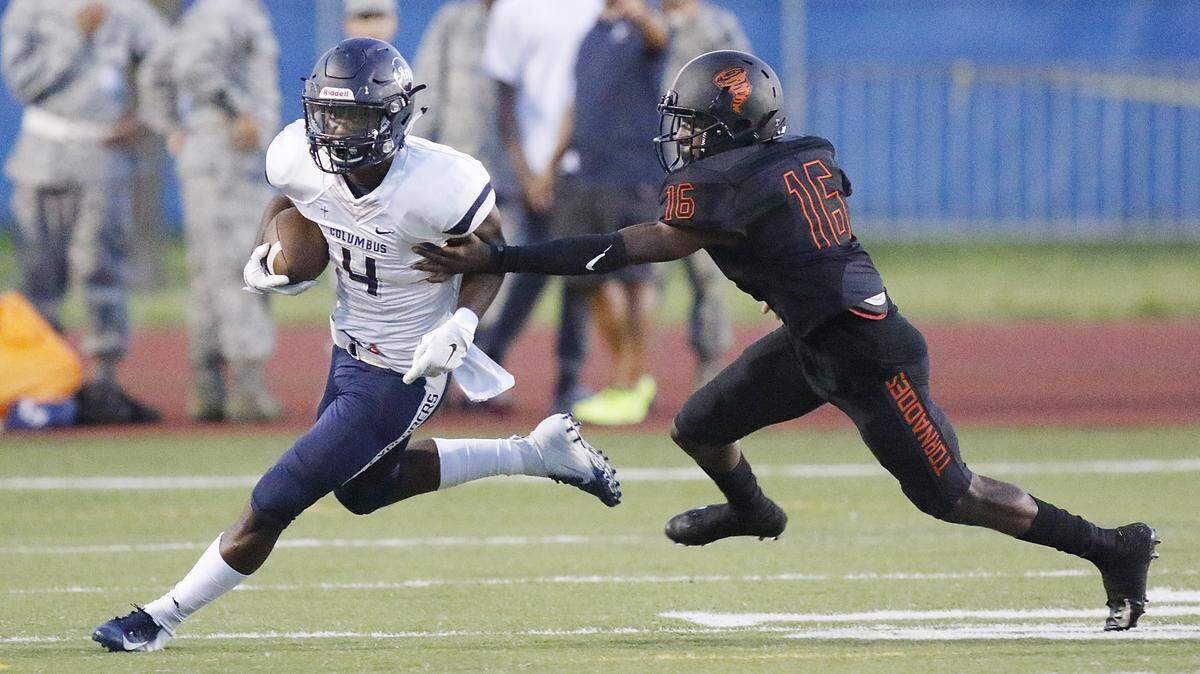 Columbus Explorers’ Henry Parrish (4) runs the ball against Booker T. Washington Tornadoes during the football game on Friday, September 14, 2018 at Curtis Park Stadium in Miami