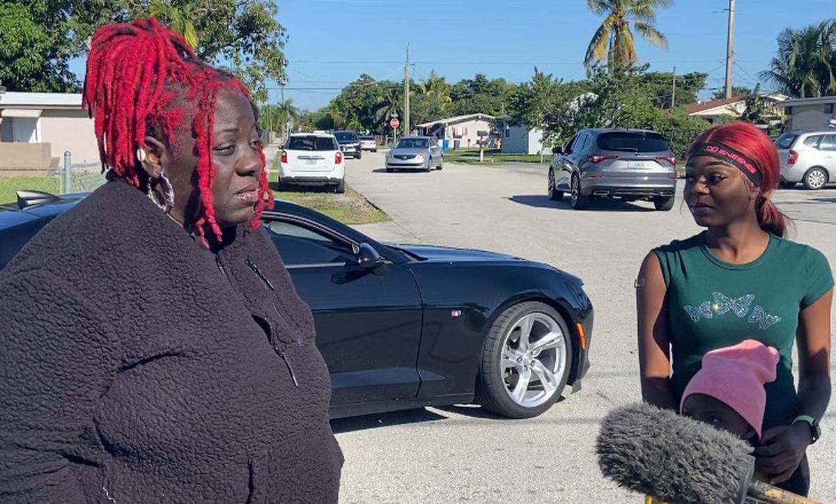Shere Whitaker explains to reporters the moment she saw Khadijah Orr, on the right, running down the street after a house exploded early Tuesday morning, Dec. 19, 2023, in West Park, Florida.