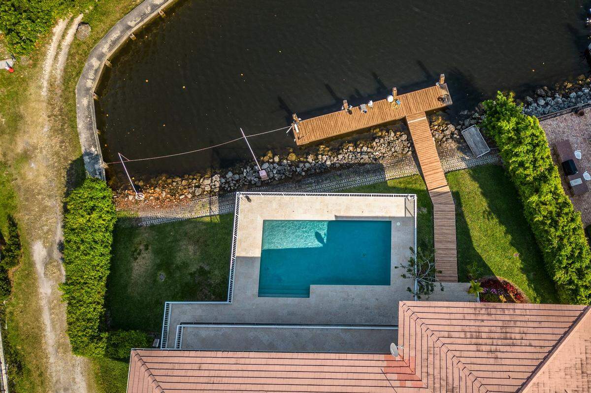 View of the Coral Gables home of Carlos Alonso where fish and wildlife police say a boat matching the description of the vessel that struck and killed Ella Adler, a 15-year-old Ransom Everglades student, off Key Biscayne Saturday was located and seized from the dock, on Tuesday, May 14, 2024.