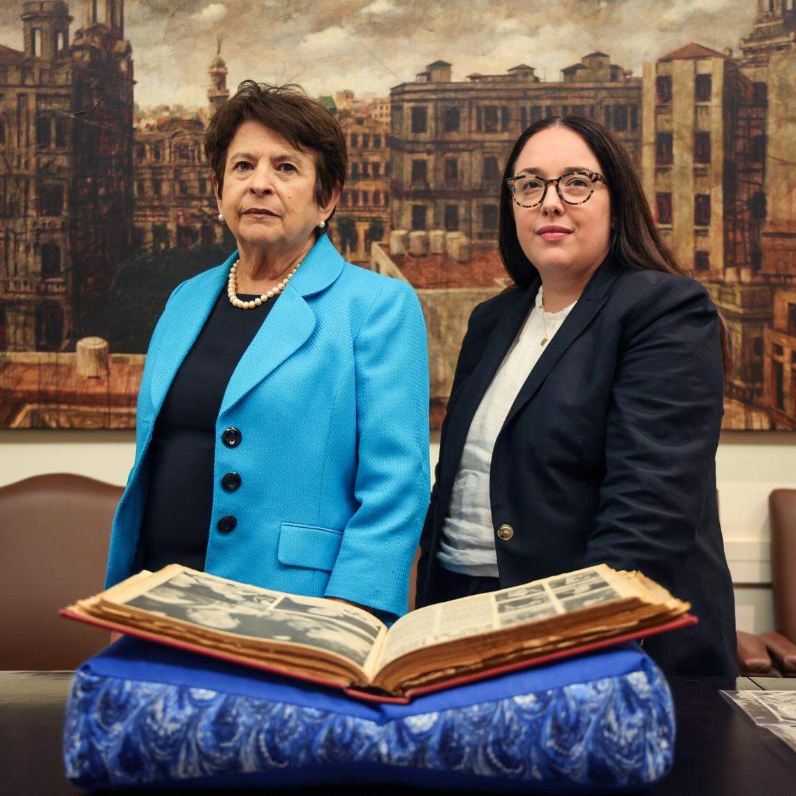 Community Relations Coordinator for Cuban Heritage Collection Gladys Gómez-Rossié, left, and Amanda Moreno, right, director of the Cuban Heritage Collection, stand among one of the items in the collection regarding the Miss Cuba pageant both in Miami and in Cuba at the University of Miami Cuba Heritage Collection.
