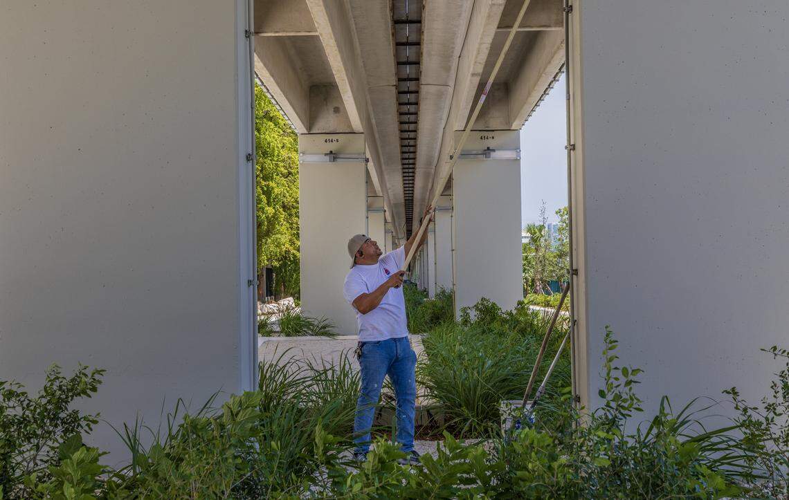 Adrian Mendoza finishes painting some columns on the Underline extension that extends between SW 19th Ave. - SW 27th Ave, on Wednesday, August 20, 2025. 