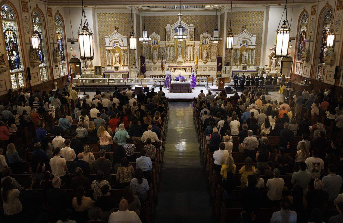 Fr. Orlando Portalatin, a Jesuit priest, leads Ash Wednesday mass on Wednesday, Feb. 18, 2026, at Gesu Catholic Church in downtown Miami.  The mass was fully packed with standing room only at the back of the church. 
