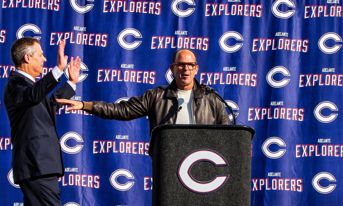Columbus’ President Thomas Kruczek, left, reacts as his Marcus Lemonis announces to all students and staff at his $10 million donation to his alma mater, Christopher Columbus High School, in Miami, on Thursday, Dec. 9, 2021.