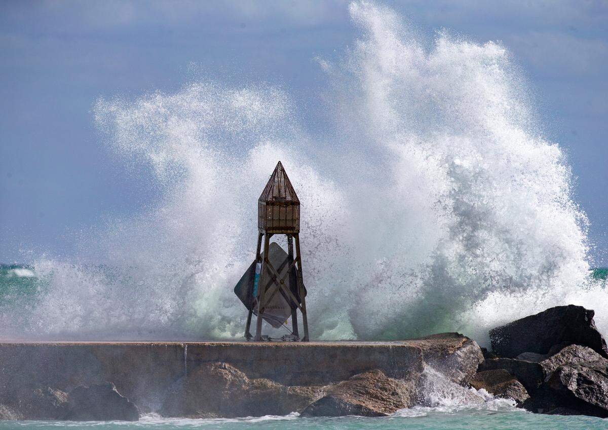 Waves crash against the jetty at the Bal Harbour Lighthouse in this file photo from Nov. 18, 2020 in Bal Harbour, Florida. A repeat is likely April 30, 2022 and for a number of days as scattered thunderstorms are in the daily forecast for much of Miami-Dade and Broward.