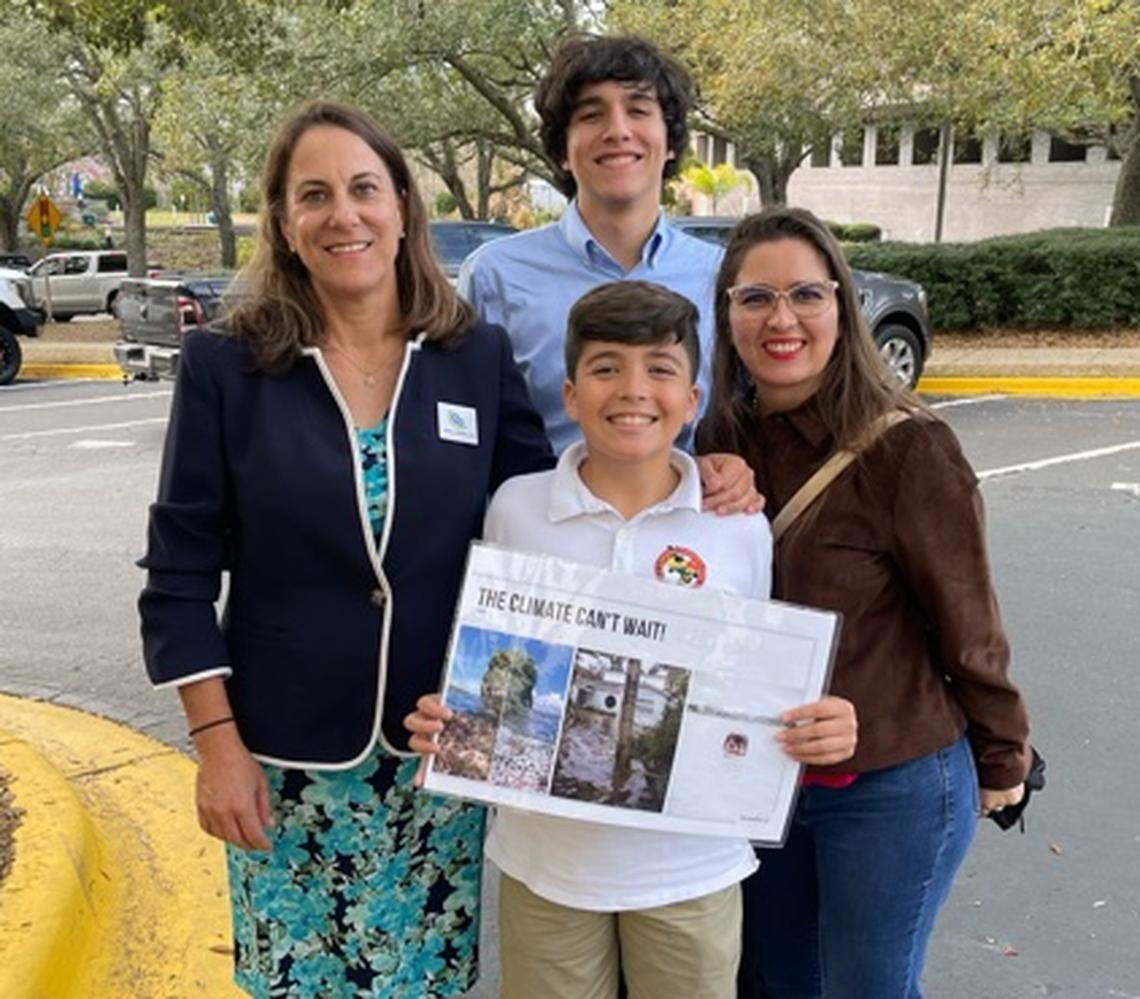 Michele Drucker, left, the environmental chair of the Miami-Dade PTA, traveled to Tallahassee Feb. 21, 2022, with students Thomas Brulay of MAST Academy and Marcel Borges, a student from G.W. Carver Middle School, along with Borges’ mother, Jacquelina Henriquez-Reyes. They came to testify before a House committee against HB 741, which reduces the financial benefits for rooftop solar users in Florida.