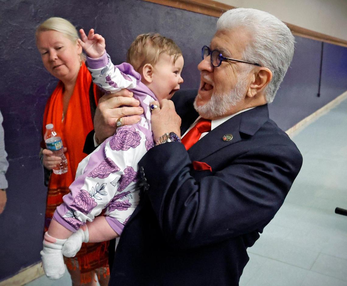 The father of Shannon Melendi, Luis Melendi, carries his granddaughter Mackayla Benton after presentations during the Shannon Melendi 30th Commemorative Senior Safety Assembly sponsored by the Shannon Melendi 30th Commemorative Committee at Southwest Miami Senior High School in Miami, Florida on Tuesday, March 19, 2024.