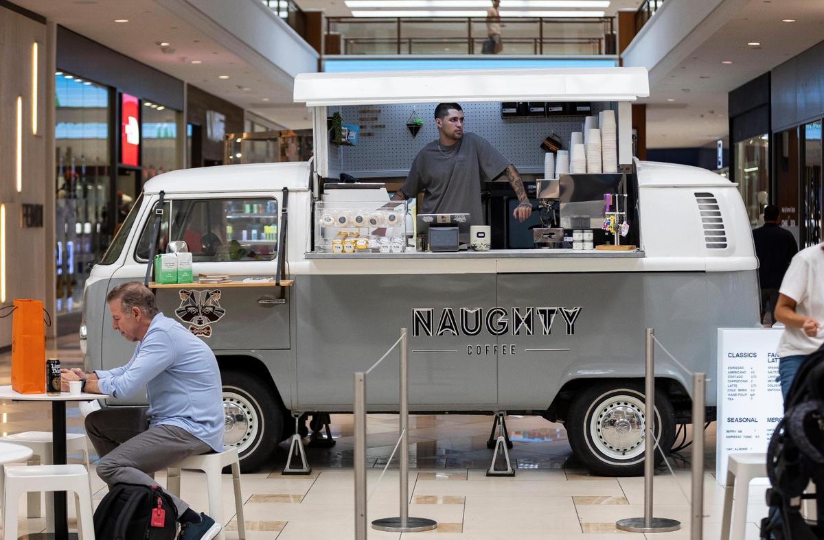 Lucca Sorgente, 25, of Naughty Coffee, is ready to serve beverages to customers from a 1972 VW van at Aventura Mall on Wednesday, Sept. 25, 2024, in Aventura, Fla.