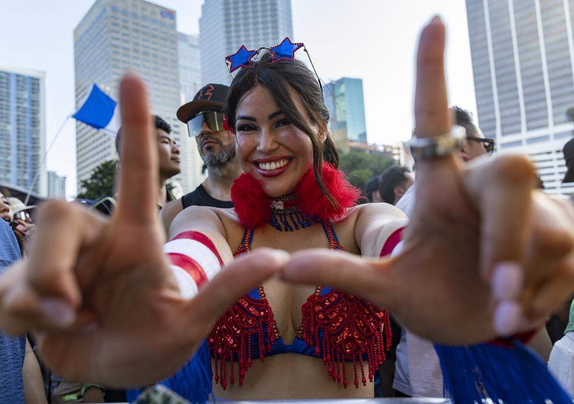 Nahyua Muniz makes a ‘U’ with her hands as Alan Walker performs during Ultra Music Festival’s 26th anniversary at Bayfront Park on Saturday, March 28, 2026, in downtown Miami, Fla.