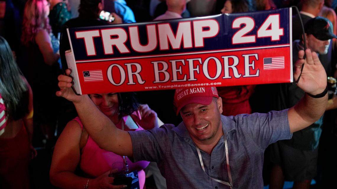 A man holds a sign before Florida Republican Gov. Ron DeSantis speaks to supporters during an election night party, in Tampa, Florida on Nov. 8.